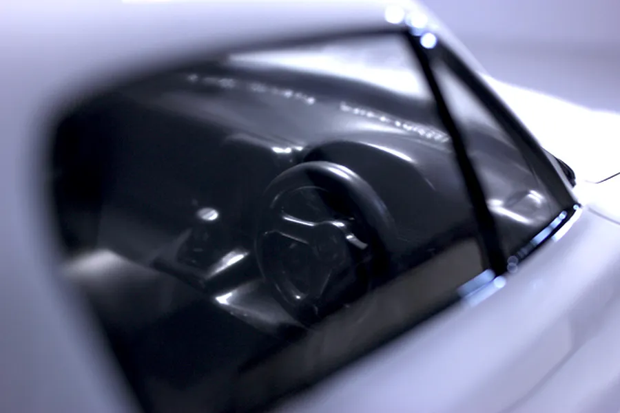 Close-up view of the interior dashboard and steering wheel inside the Mazda Eunos Roadster body shell.