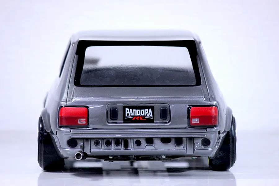 Rear view of the painted Pandora RC Toyota Starlet KP61 late model RC body shell in metallic grey with a Pandora RC license plate and exhaust tip.