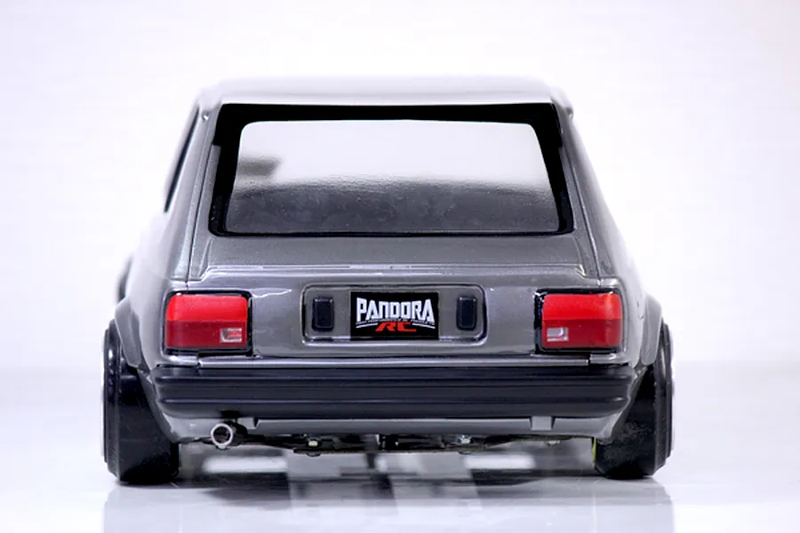 Rear view of a painted grey Toyota Starlet KP61 RC body shell with Pandora RC license plate against a white background.