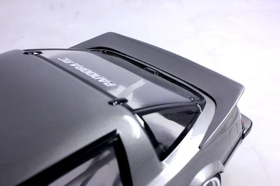 Close-up rear quarter view of a grey Pandora RC Mazda Savanna RX-7 body shell showcasing the hatch and spoiler.