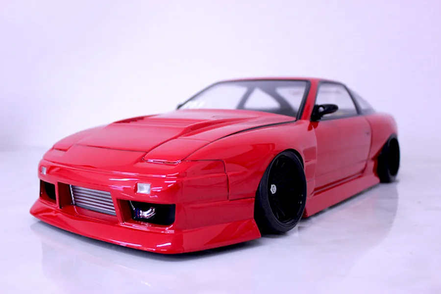 Red Pandora RC RPS13 180SX drift body shell mounted on an RC chassis with black wheels and a front intercooler.