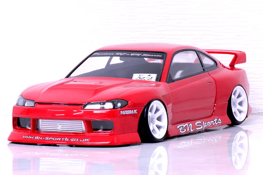 Red RC drift car body shell modelled after the S15 Silvia with BN Sports styling, white wheels, and a reflective white background.