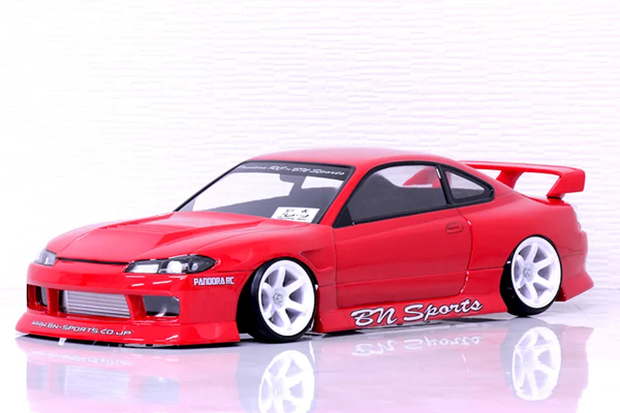 Red Pandora RC S15 Silvia BN Sports body shell mounted on an RC drift chassis with white wheels.