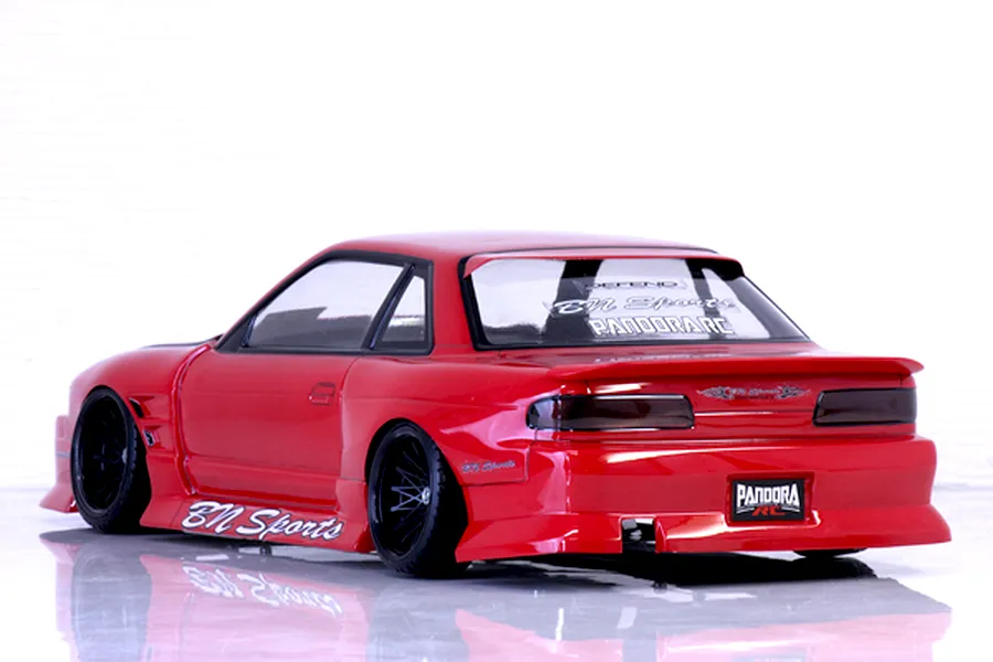 Rear three-quarter view of a painted red RC drift car body styled as an S13 Silvia with BN Sports decals against a white background.