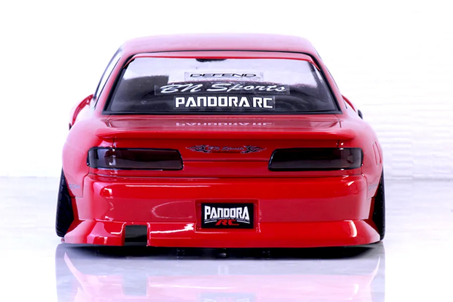 Rear view of a red Pandora RC S13 Silvia drift body shell featuring BN Sports decals and tinted taillights on a reflective white surface.
