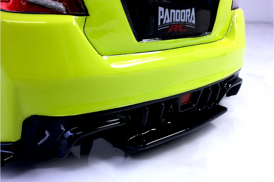 Close-up of the bright yellow rear bumper and black diffuser on a Pandora RC Subaru WRX STI body shell.