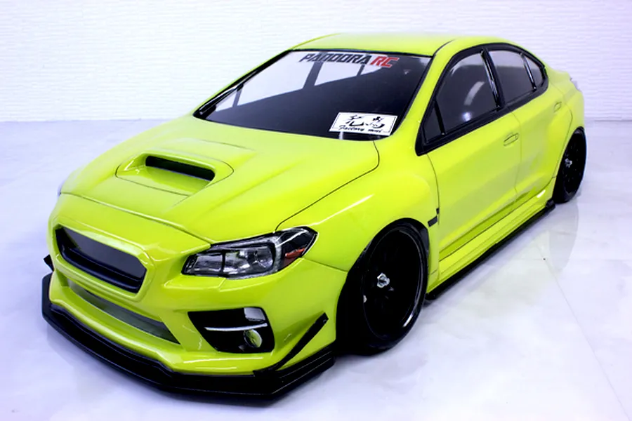 Bright neon green painted RC drift car body shell mounted on a chassis with black wheels against a white background.