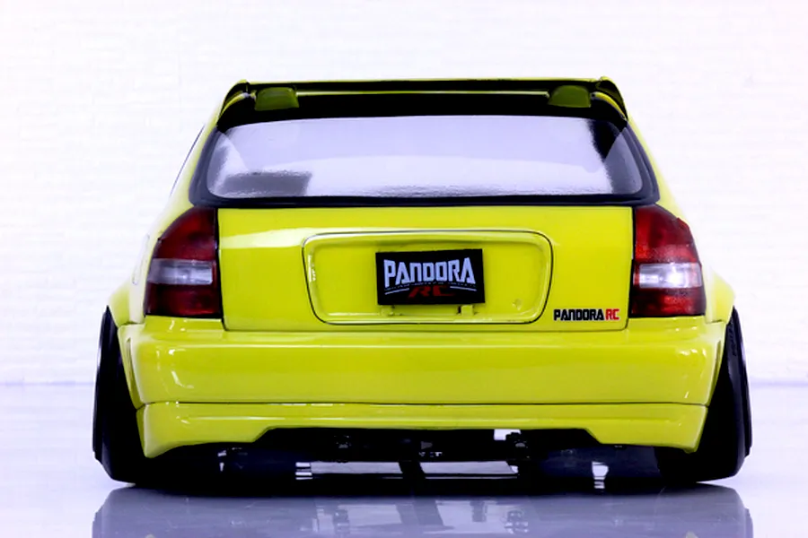 Rear view of a yellow Honda Civic EK9 RC body shell by Pandora RC showcasing the spoiler and decals on a white background.