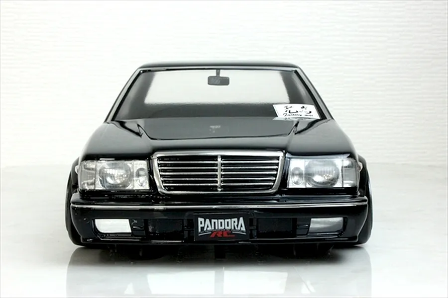 Front view of a black Y31 Cedric Sedan RC body shell by Pandora RC with chrome grille and bumpers.