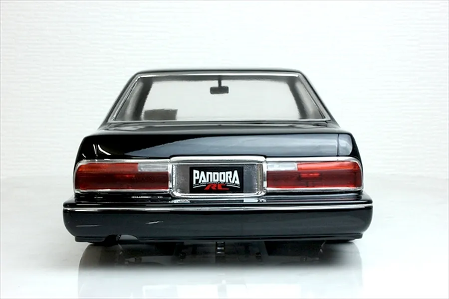 Rear view of the Pandora RC Y31 Cedric Sedan body shell painted black, showing tail lights and brand license plate.