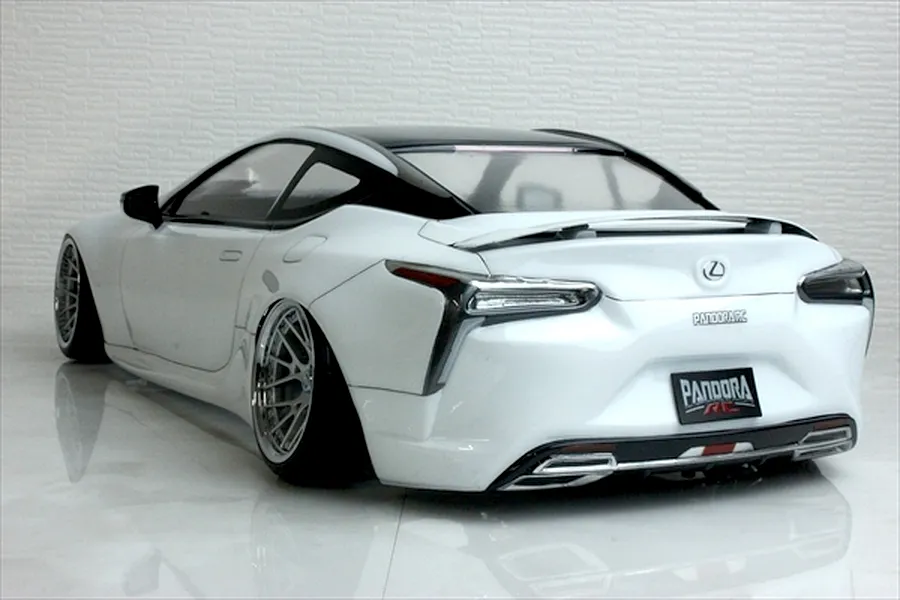 Rear three-quarter view of a white Pandora RC Lexus LC drift body shell on a reflective studio surface.