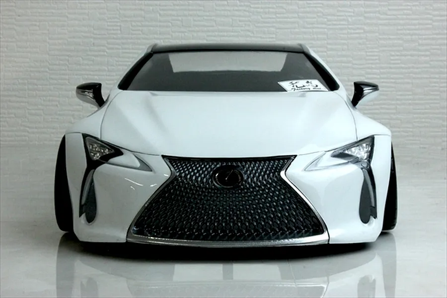 Front view of a white Pandora RC Lexus LC 7800 body shell showcasing the detailed spindle grille, headlights, and side mirrors.