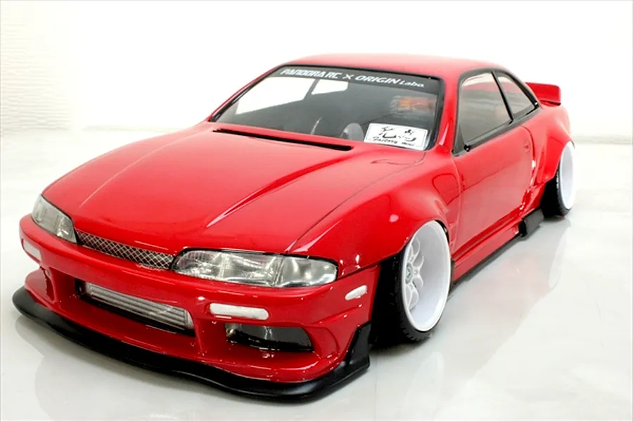 Red S14 Silvia early model RC drift car body shell by Pandora RC with wide fenders and white wheels against a white background.