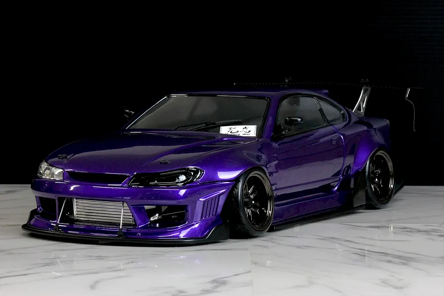 Custom painted purple metallic RC drift car body styled as a Nissan S15 Silvia on a marble surface.