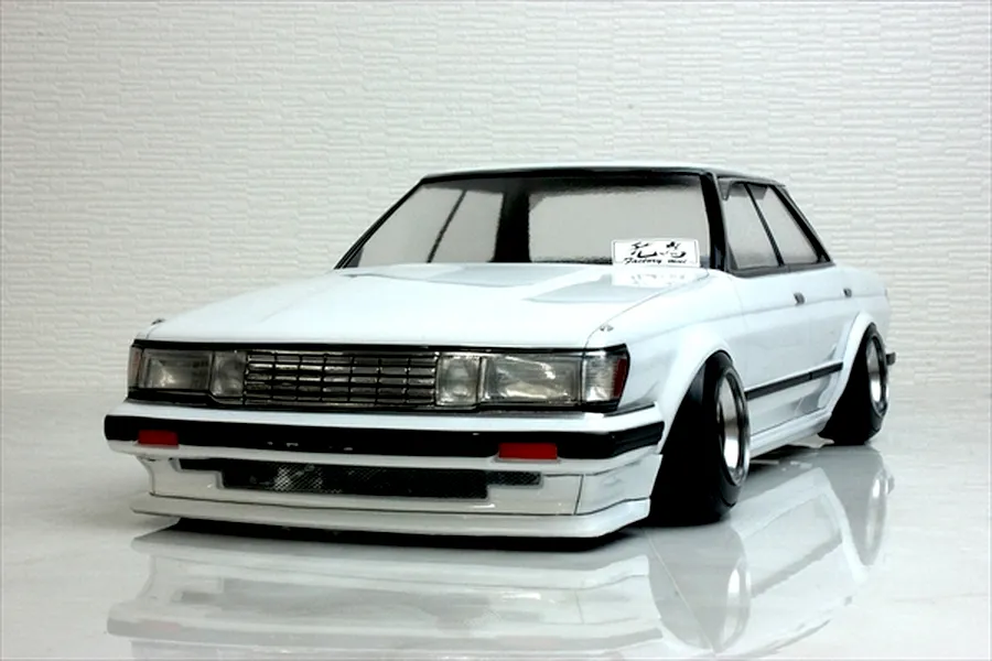 A painted white Pandora RC Toyota Mark 2 GX71 body shell mounted on an RC chassis with deep-dish wheels against a white background.
