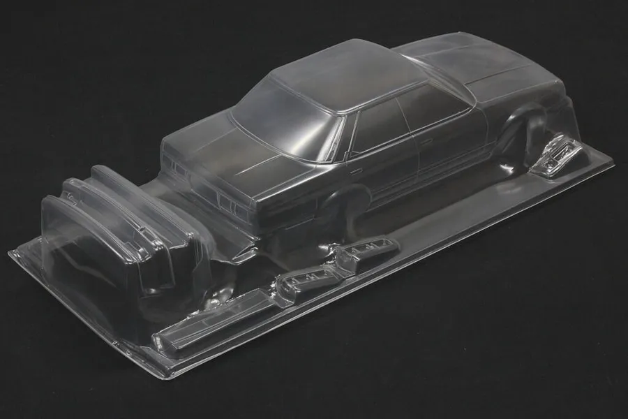 Unpainted clear polycarbonate RC car body shell for Toyota Mark 2 GX71 on a dark surface.