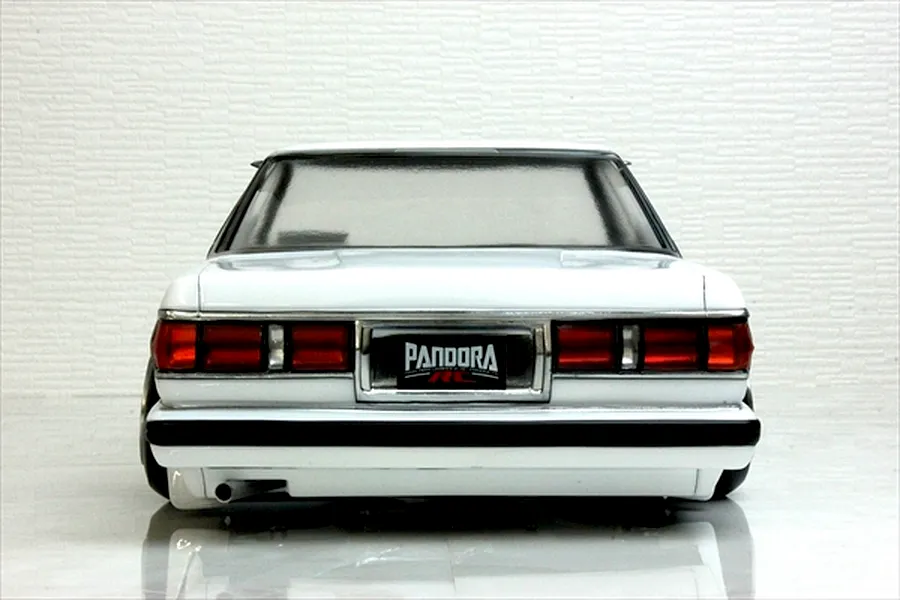 Rear view of the painted white Pandora RC Toyota Mark 2 GX71 body shell featuring taillights and a Pandora RC license plate.