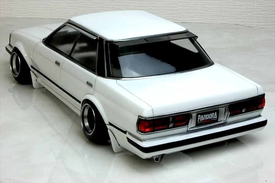 Rear high-angle view of a painted white Pandora RC Toyota Mark 2 GX71 RC body shell with black window trim and deep dish wheels.
