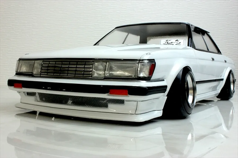 Front view of a white RC drift car body styled like a Toyota Mark 2 GX71 on a reflective surface.