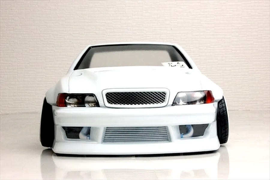 Front view of a white Toyota Chaser JZX100 RC drift car body shell with custom front bumper, wide fenders, and visible intercooler.