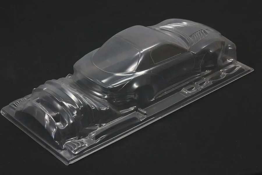 Unpainted clear polycarbonate RC car body shell for a Mazda RX-7 FD3S shown from a high rear angle on a dark background.