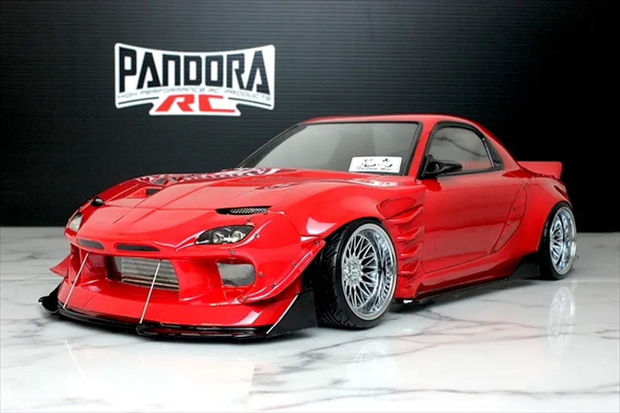 Red Pandora RC Mazda RX-7 FD3S RC drift car body shell on a marble surface with Pandora RC logo backdrop.
