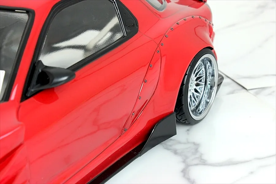 Close-up of the red RC car body shell highlighting the rear fender flare and side skirt.