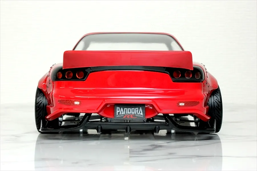 Rear view of a red Pandora RC Mazda RX-7 FD3S BN Sports drift car body on a reflective surface.