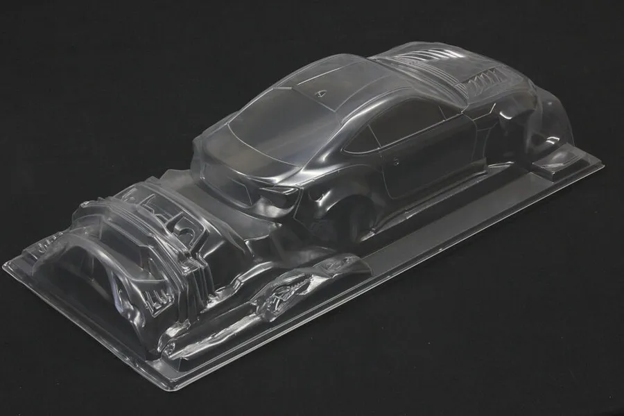 Unpainted clear polycarbonate RC car body shell for Toyota 86 ZN6 BN Sports shown on a black background.