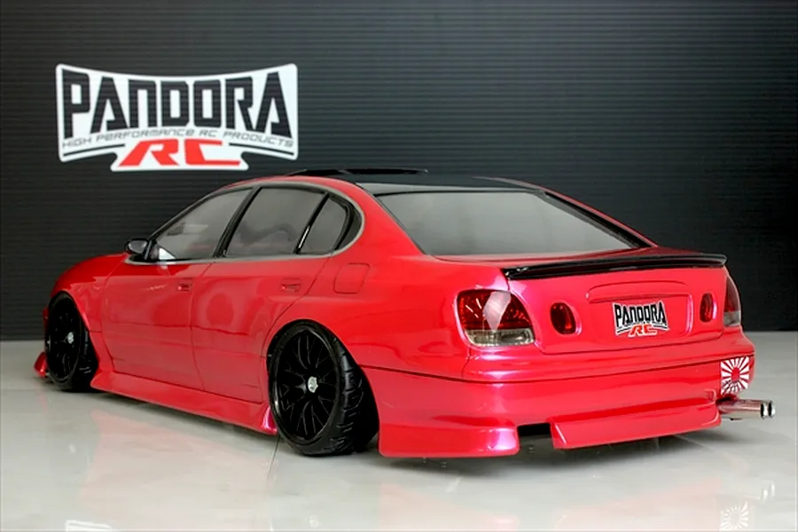 Rear three-quarter view of a painted red Pandora RC Toyota Aristo JZS161 body shell on a glossy studio floor with Pandora logo background.