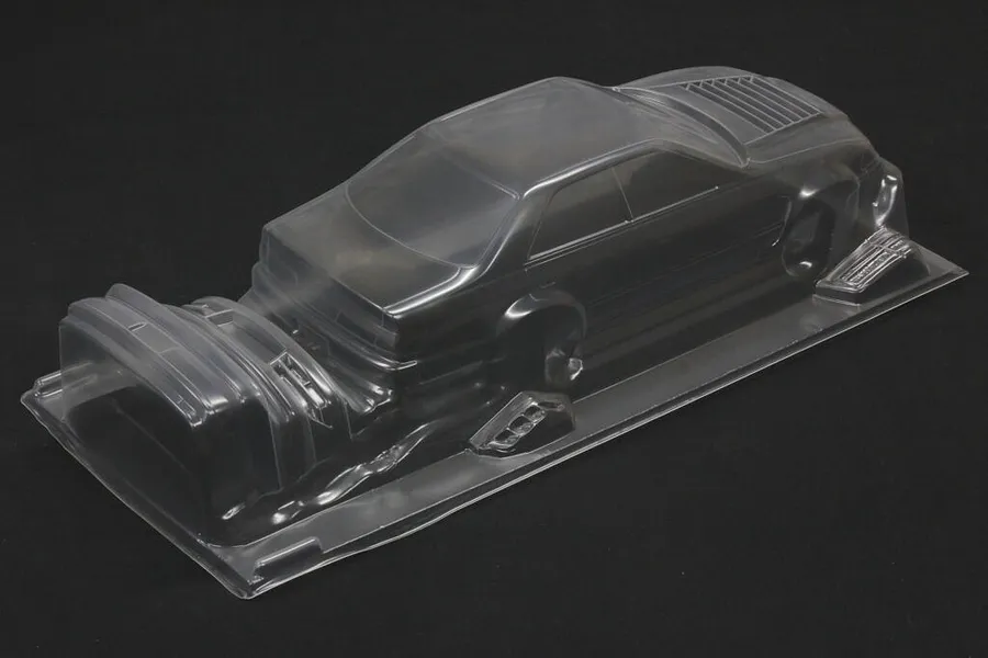 Unpainted clear polycarbonate RC car body shell for Toyota Mark II on a dark surface.