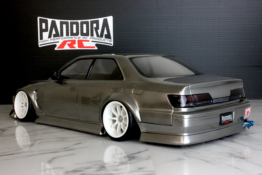 Rear-three-quarter studio view of a grey Pandora RC Toyota Mark 2 JZX100 drift body on a reflective surface.