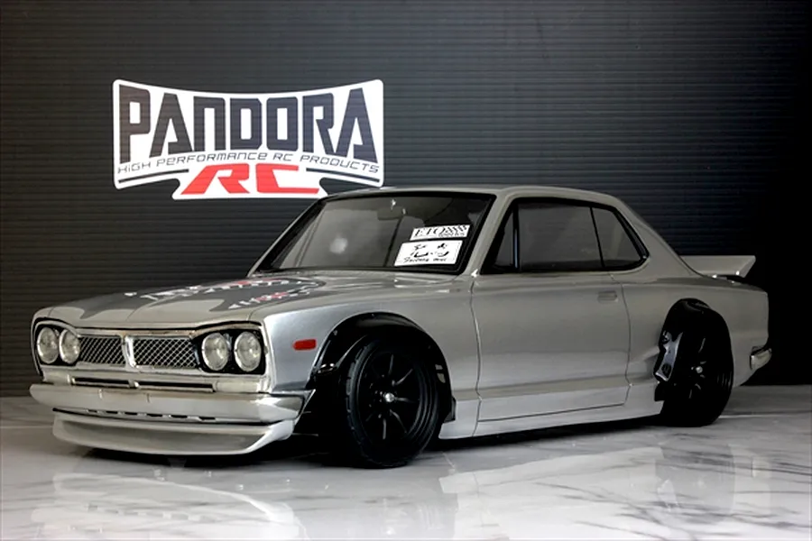 A silver Pandora RC KPGC10 Skyline GT-R Hakosuka RC drift car body mounted on a chassis with black wheels.