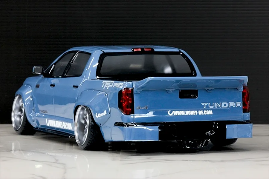 Rear three-quarter view of a light blue Pandora RC Toyota Tundra RC drift car body with wide fenders and custom wheels.