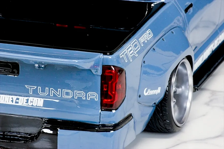 Close-up of the rear quarter and tailgate of a blue Toyota Tundra RC body shell with fender flares, TRD Pro decals, and custom wheels.