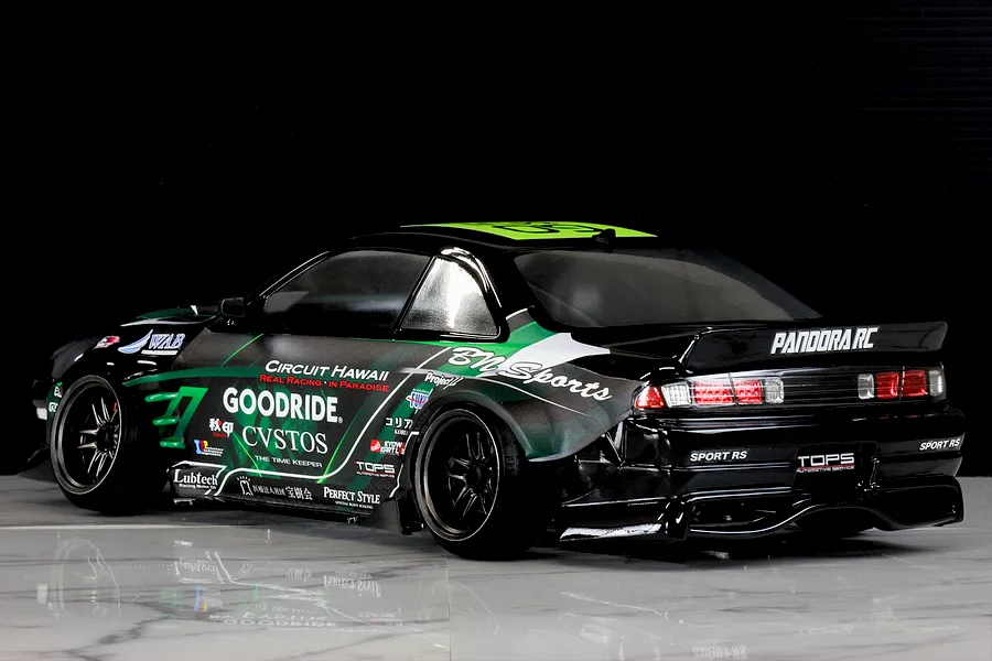 Side-rear view of a black Pandora RC S14 Silvia RC drift car with green and white BN Sports livery parked on a glossy surface.