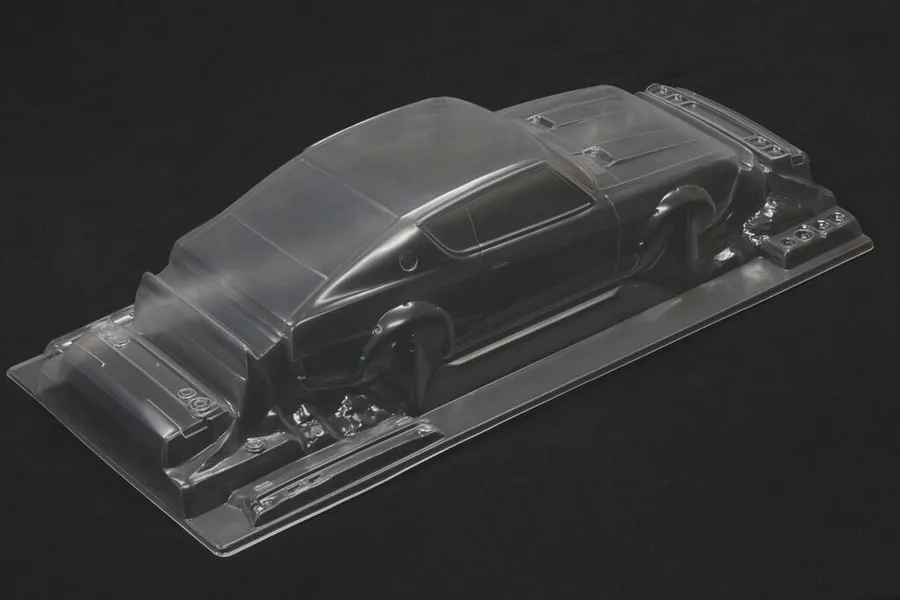 Unpainted clear polycarbonate RC car body shell on a black background, viewed from above and behind.