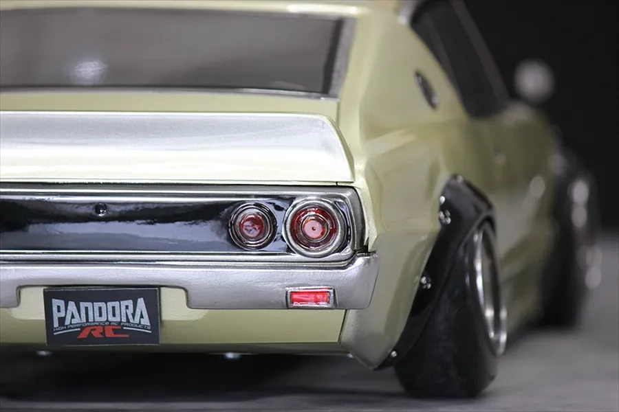 Close-up rear angle of Pandora RC KPGC110 Skyline 2000GT-R drift body shell in pale gold with black fender flares.