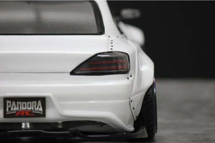 Close-up rear view of a white RC drift car body shell showing the rear fender flare, tail light, and Pandora RC license plate.