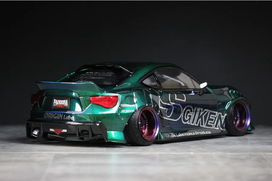 Rear three-quarter view of a metallic green RC drift car body shell styled as a Toyota 86 with custom decals and deep dish wheels.