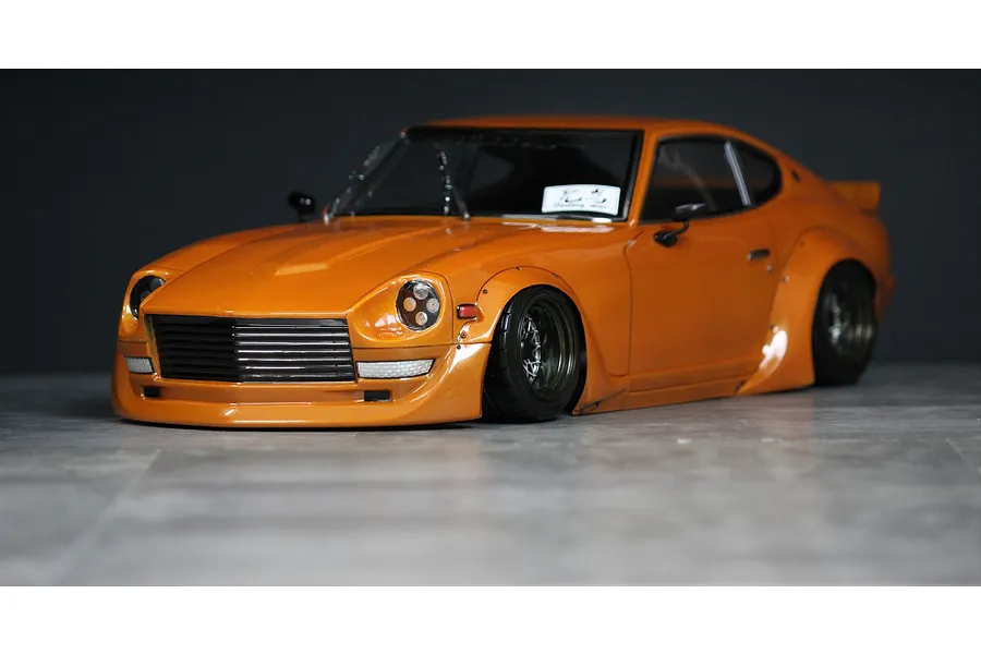 Orange Pandora RC S30 Fairlady Z Star Road drift body shell mounted on a low chassis.