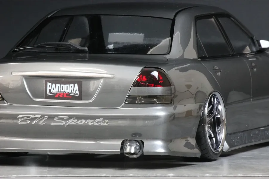 Rear view of grey Pandora RC Toyota Mark 2 JZX110 drift body shell featuring BN Sports branding, custom exhaust, and detailed taillights.
