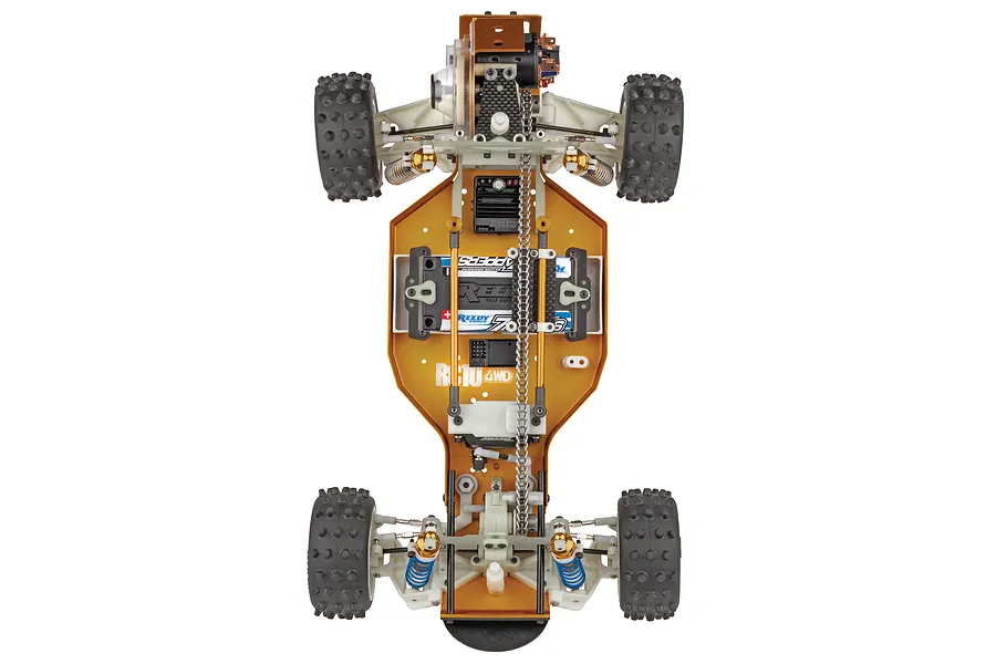 Top down studio view of the Team Associated RC10 4WD buggy chassis showing the gold anodised aluminum plate and internal chain drive.