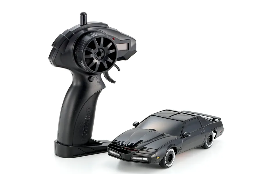 Kyosho Mini-Z Knight Rider RC car and black pistol-grip transmitter on a white background.