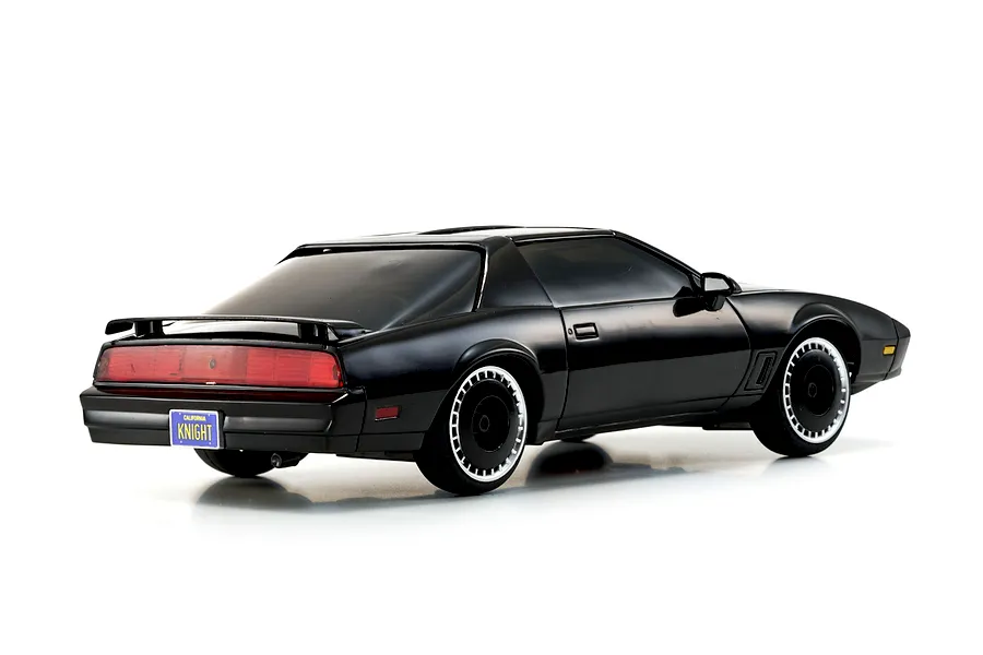 Rear three-quarter view of the Kyosho Mini-Z Knight Rider RC car showcasing its black body, turbine wheels, and California KNIGHT license plate on a white background.