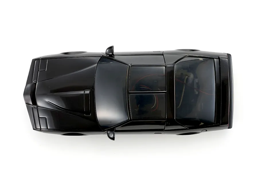 Top-down studio shot of the Kyosho Mini-Z Knight Rider RC car body in glossy black, showing hood details and tinted windows.