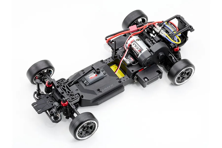 Top down studio shot of the unpainted chassis of the Kyosho Fazer D2 RC drift car without body shell on a white background.