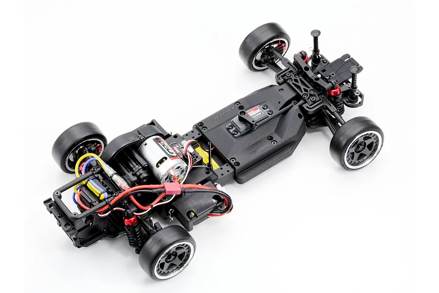 Top down studio view of the Kyosho Fazer D2 RC drift car chassis showing electronic components and motor on a clean white background.