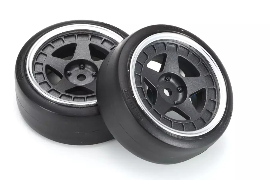 Two black RC drift car wheels with five-spoke rims and silver lips on a white background.