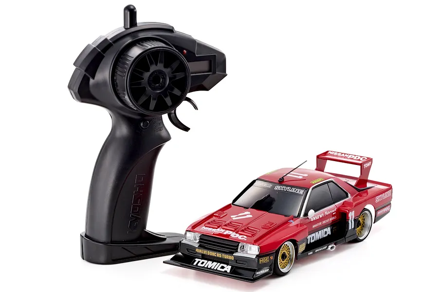 Kyosho First Mini-Z 1982 Nissan Super Silhouette RC car in red and black with matching black pistol-grip transmitter on a white background.